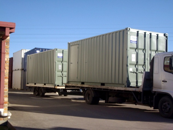 Our Fleet - Truck & trailer transporting containers